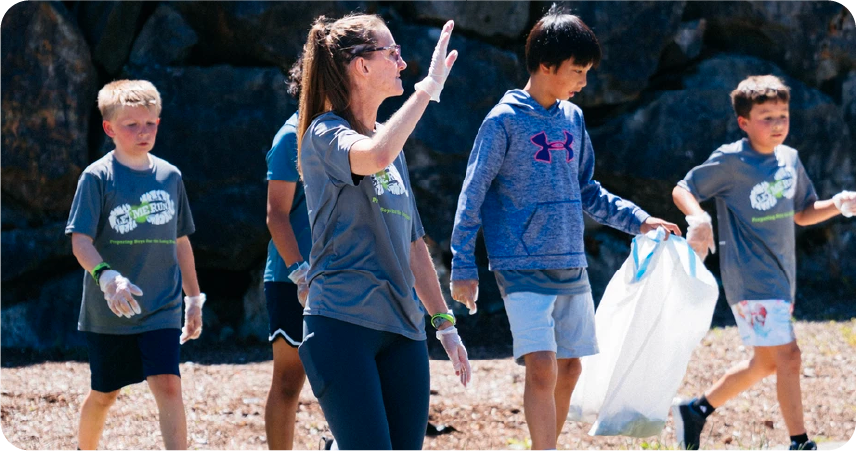 assistant coach waving to runners