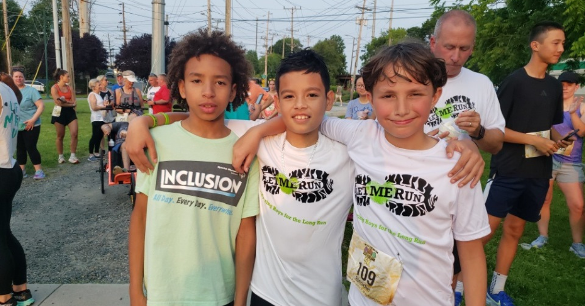 three boys after 5k run smiling