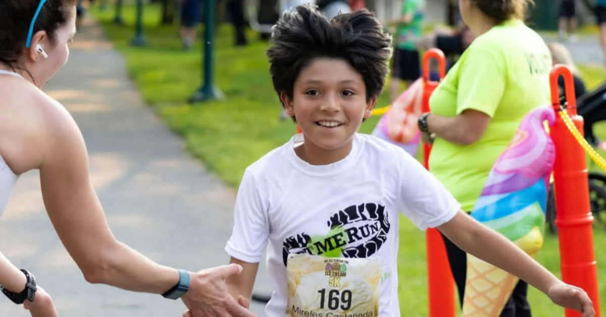 boy high fiving bystander during let me run 5k